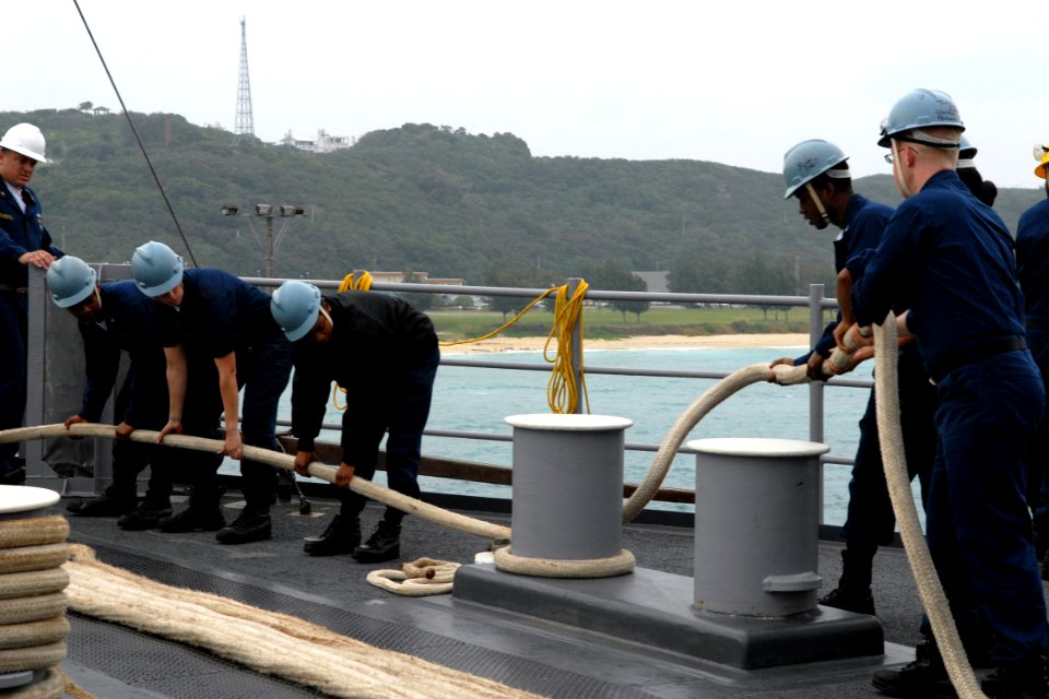 US Navy 100125-N-6692A-020 Sailors tend a mooring line during sea and anchor detail aboard the amphibious dock landing ship USS Harpers Ferry (LSD 49)
