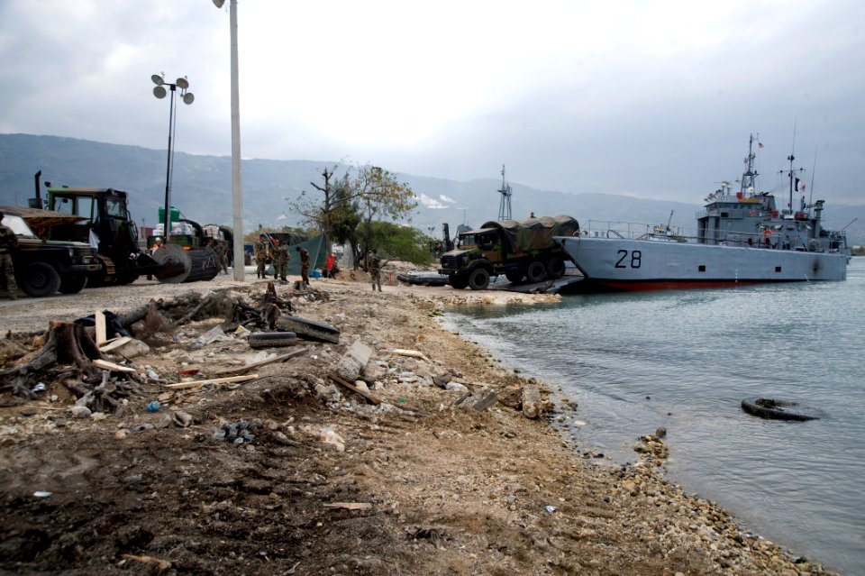 US Navy 100125-N-1134L-264 Service members from France offload heavy equipment in the main seaport of Port-au-Prince, Haiti