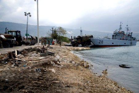 US Navy 100125-N-1134L-264 Service members from France offload heavy equipment in the main seaport of Port-au-Prince, Haiti photo
