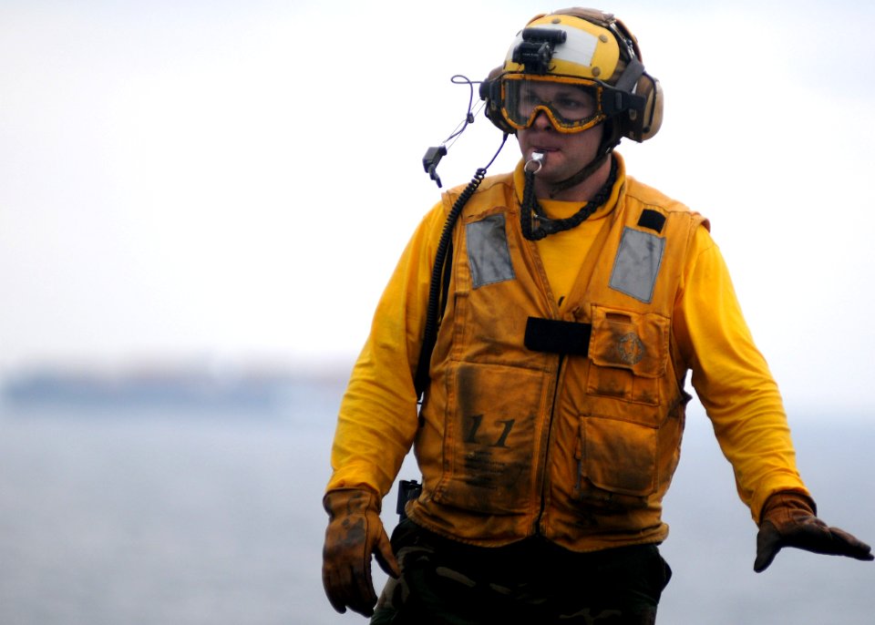 US Navy 100125-N-5215E-032 Aviation Boatswain's Mate (handling) 2nd Class Eric Ballard works on the flight deck