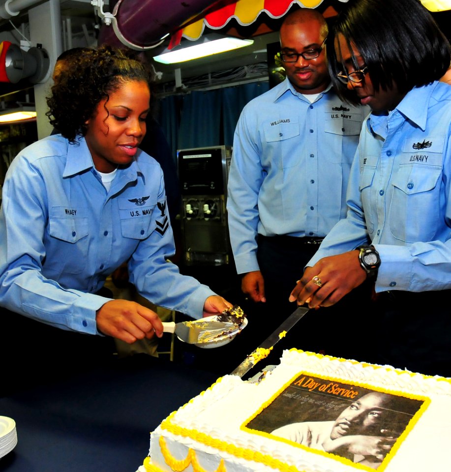 US Navy 100125-N-7939W-039 Sailors take part in a cake cutting ceremony during a celebration honoring the Rev. Dr. Martin Luther King Jr. aboard the aircraft carrier USS Nimitz (CVN 68)