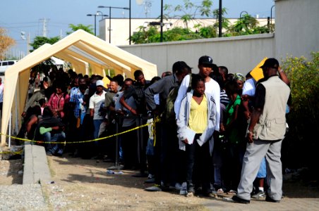 US Navy 100126-N-6247V-043 Hundreds of Haitian-Americans stand in line in front of the U.S. Embassy in Port-au-Prince, Haiti photo