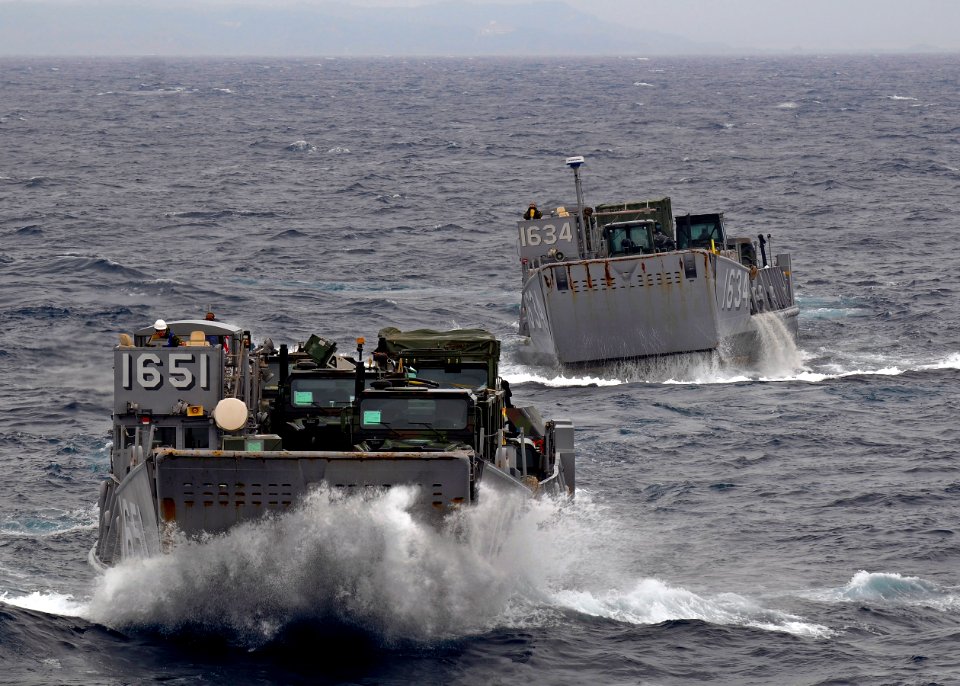 US Navy 100125-N-9950J-029 Two landing craft utility vehicles assigned to Assault Craft Unit (ACU) 1 approach the well deck of the forward-deployed amphibious assault ship USS Essex (LHD 2)