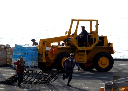 US Navy 100125-N-4971L-426 Sailors and Marines onload stores and relief supplies aboard the amphibious dock landing ship USS Fort McHenry (LSD 43)