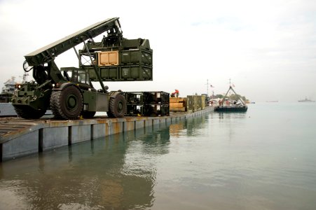 US Navy 100126-N-1134L-335 Marines assigned to 8th Engineer Support Battalion unload supplies from a floating causeway offloaded from the Military Sealift Command maritime prepositioning ship USNS 1st Lt. Jack Lummus (T-AK 3011 photo