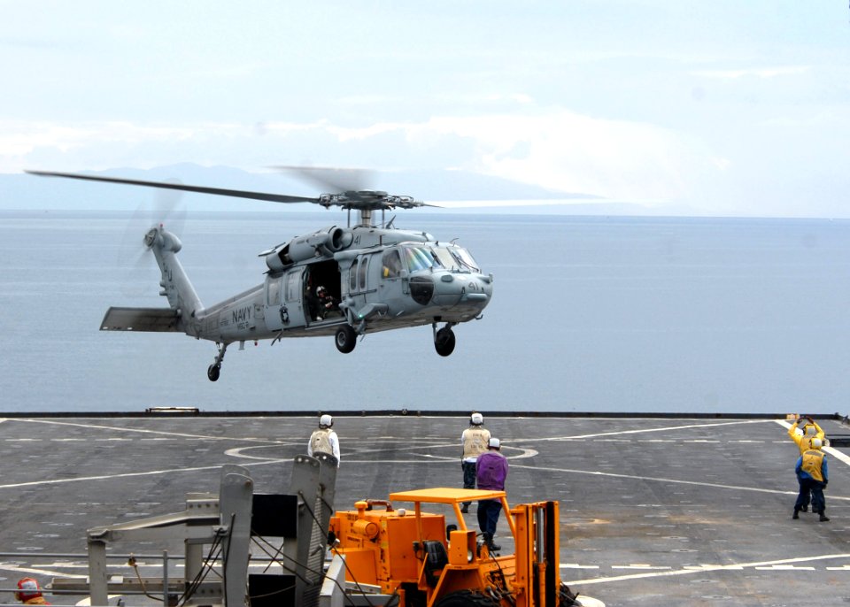US Navy 100125-N-4971L-292 An MH-60S Sea Hawk Helicopter from Helicopter Sea Support Squadron (HSC) 2 delivers stores and relief supplies to the amphibious dock landing ship USS Fort McHenry (LSD 43)