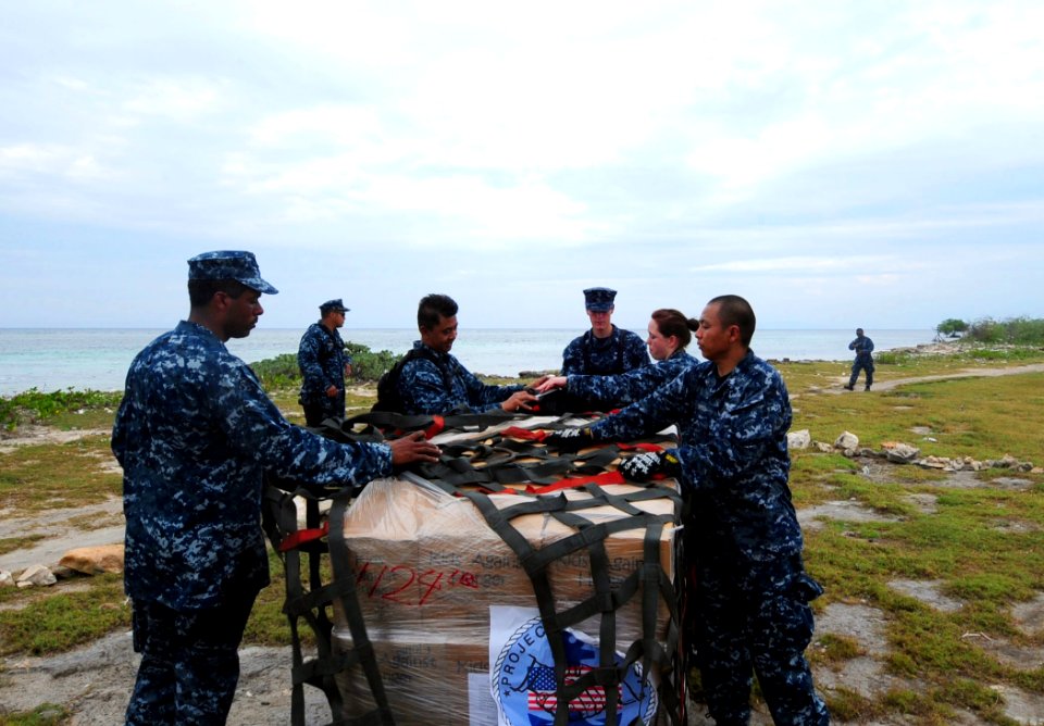 US Navy 100126-N-2953W-331 Sailors assigned to the guided-missile cruiser USS Bunker Hill (CG 52) unload relief supplies from the non-profit organization, Kids Against Hunger