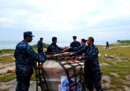 US Navy 100126-N-2953W-331 Sailors assigned to the guided-missile cruiser USS Bunker Hill (CG 52) unload relief supplies from the non-profit organization, Kids Against Hunger