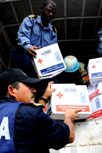 US Navy 100126-N-7948C-091 Lt. Cmdr. Samuel Ayelazono and Lt. Rafael Solis Martinez unload a U.N. truck full of humanitarian relief supplies delivered by the Mexican navy