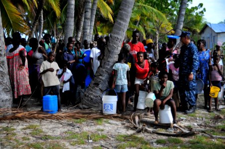 US Navy 100125-N-4774B-375 Haitian citizens wait in line for fresh water being flown in from the guided-missile cruiser USS Bunker Hill (CG 52) photo