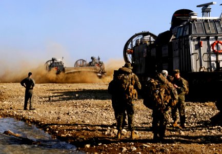 US Navy 100125-N-5345W-009 A landing craft air cushion (LCAC) from Assault Craft Unit (ACU) 4 lands in a dry riverbed to deliver equipment, Sailors from the multi-purpose amphibious assault ship USS Bataan (LHD 5)