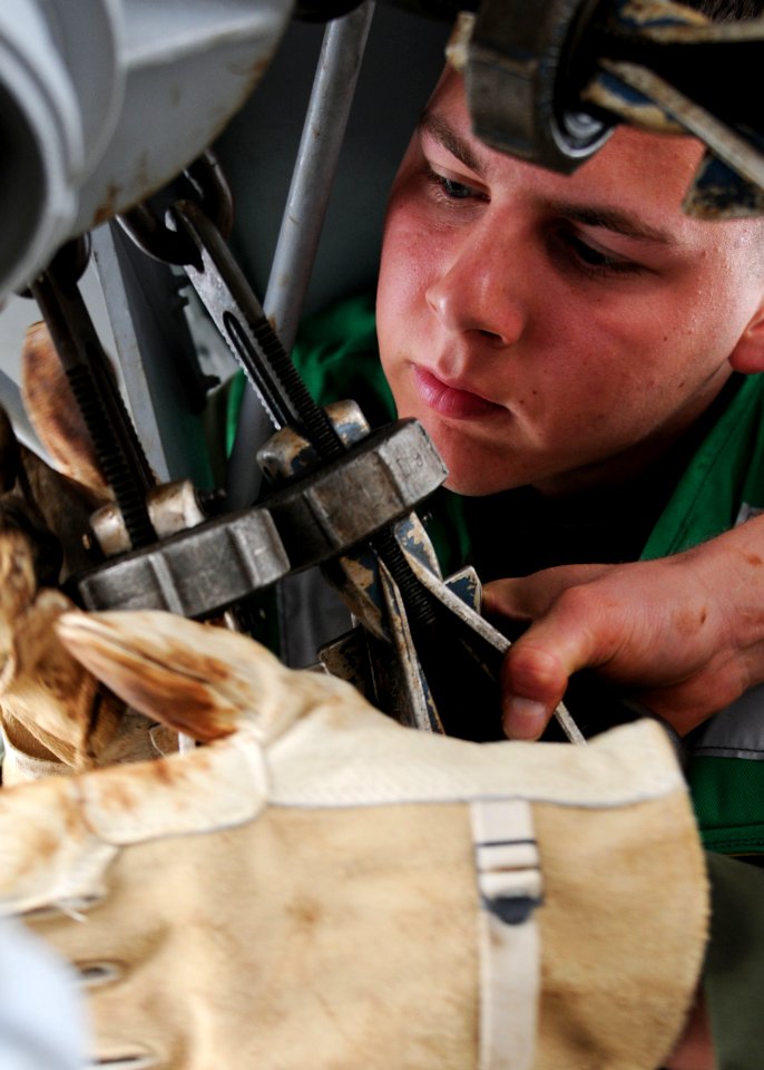 US Navy 100126-N-5538K-044 Lance Cpl. Michael Strobel secures a CH-46E Sea Knight helicopter to the flight deck of the amphibious transport dock ship USS Denver (LPD 9)