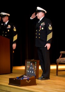 US Navy 100126-N-8053S-075 Master Chief Scott Weaver, right, command master chief, U.S.Naval Forces Central Command, salutes fellow chiefs at his retirement ceremony at Naval Support Activity Bahrain