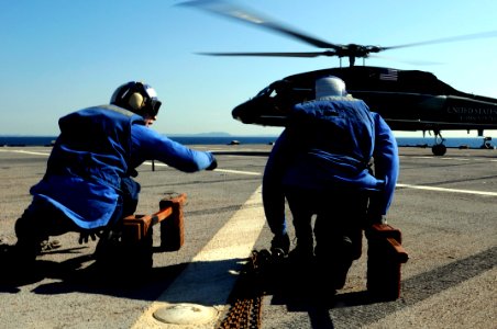 US Navy 100126-N-7478G-168 Religious Program Specialist Seaman Matthew Clinton, left, communicates with Operations Specialist 3rd Class Michael Sumlar