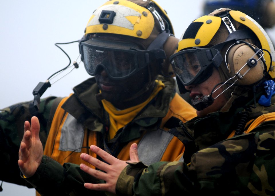 US Navy 100125-N-5215E-055 Aviation Boatswain's Mate (handling) 2nd Class Quoc Ngyuen, right, and Aviation Boatswain's Mate (handling) 3rd Class Mario Teasley