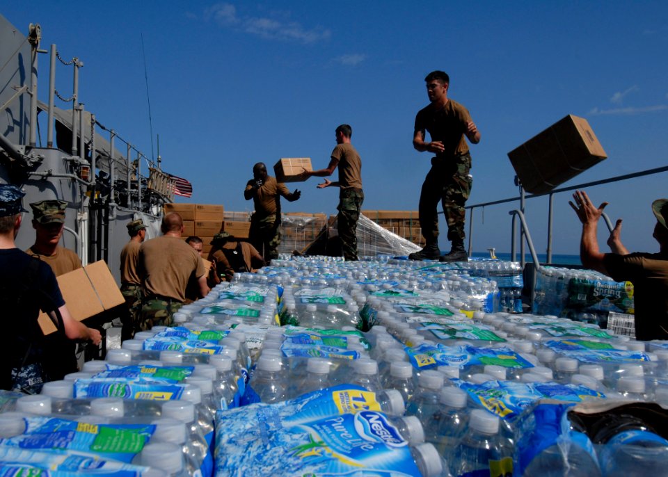 US Navy 100127-N-2000D-052 Sailors and Marines off-load food rations and water from a landing craft utility vehicle
