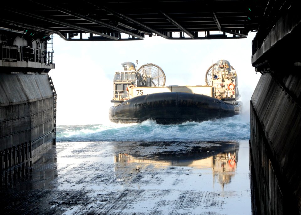 US Navy 100125-N-8607R-020 Landing Craft Air Cushioned 75, from Assault Craft Unit (ACU) 5, prepares to enter the well deck of the amphibious assault ship USS Bonhomme Richard (LHD 6)