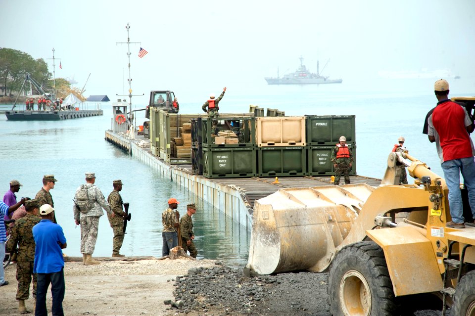US Navy 100126-N-1134L-323 A floating causeway delivers relief aid from the Military Sealift Command maritime prepositioning ship USNS 1st Lt. Jack Lummus (T-AK-3011)