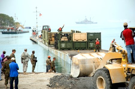 US Navy 100126-N-1134L-323 A floating causeway delivers relief aid from the Military Sealift Command maritime prepositioning ship USNS 1st Lt. Jack Lummus (T-AK-3011) photo