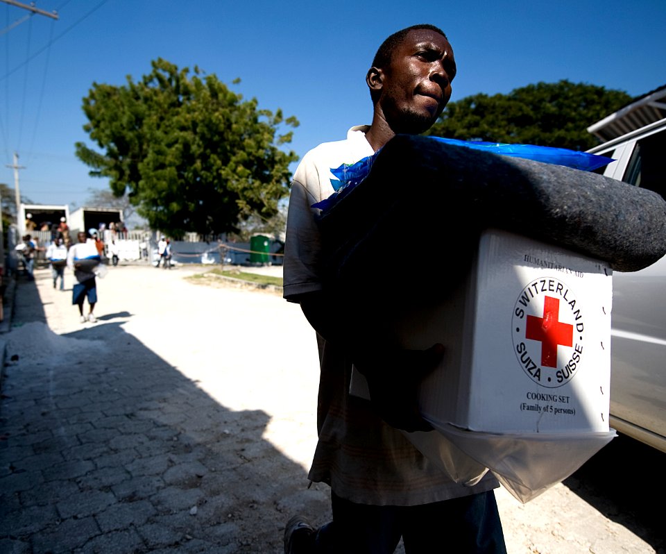 US Navy 100125-N-6266K-163 A Haitian earthquake survivor leaves a local Red Cross distribution site after receiving non-perishable items in Port-au-Prince
