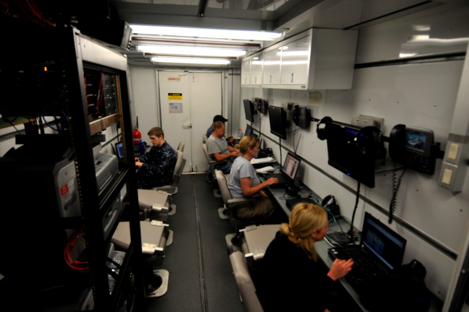 US Navy 100126-N-1831S-008 Media members transmit video, photos, and news stories of the relief efforts in Haiti from a media trailer aboard the multi-purpose amphibious assault ship USS Bataan (LHD 5)