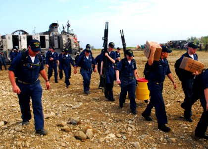 US Navy 100126-N-3165S-019 Sailors depart a landing craft air cushion en route to clear roads of rubble and distribute food to the local population of Grand Goave