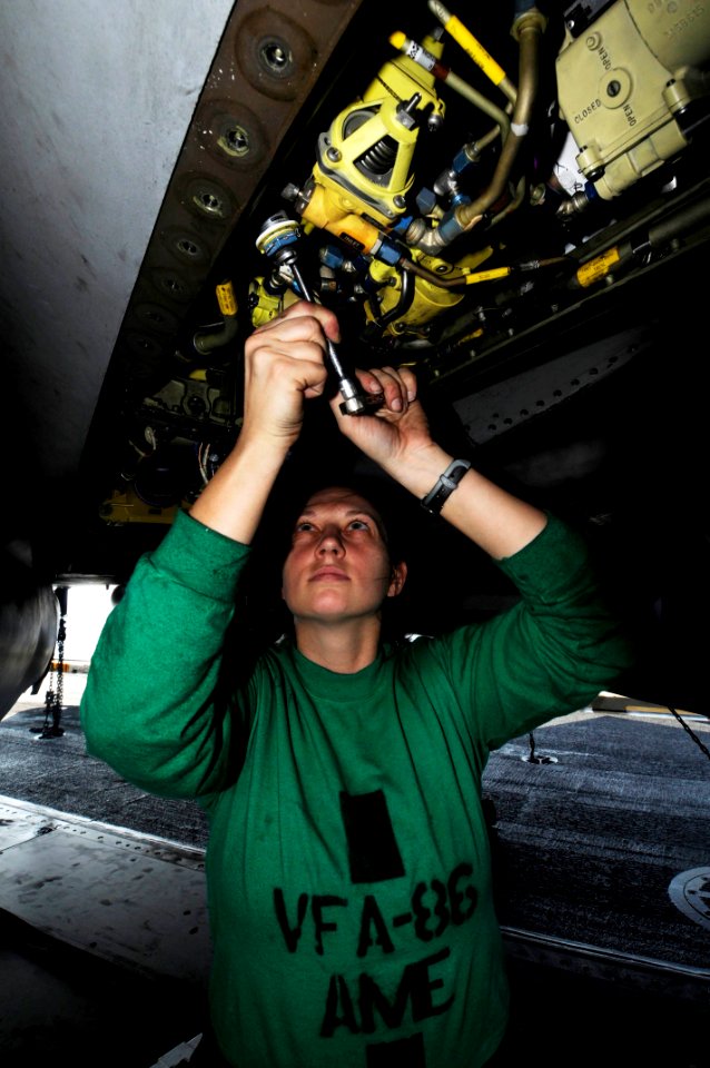 US Navy 100126-N-3038W-091 Aviation Structural Mechanic Equipment Airman Danyle Murray performs maintenance on an F-A-18C Hornet aboard the aircraft carrier USS Nimitz (CVN 68) photo