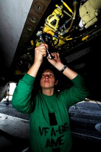 US Navy 100126-N-3038W-091 Aviation Structural Mechanic Equipment Airman Danyle Murray performs maintenance on an F-A-18C Hornet aboard the aircraft carrier USS Nimitz (CVN 68)