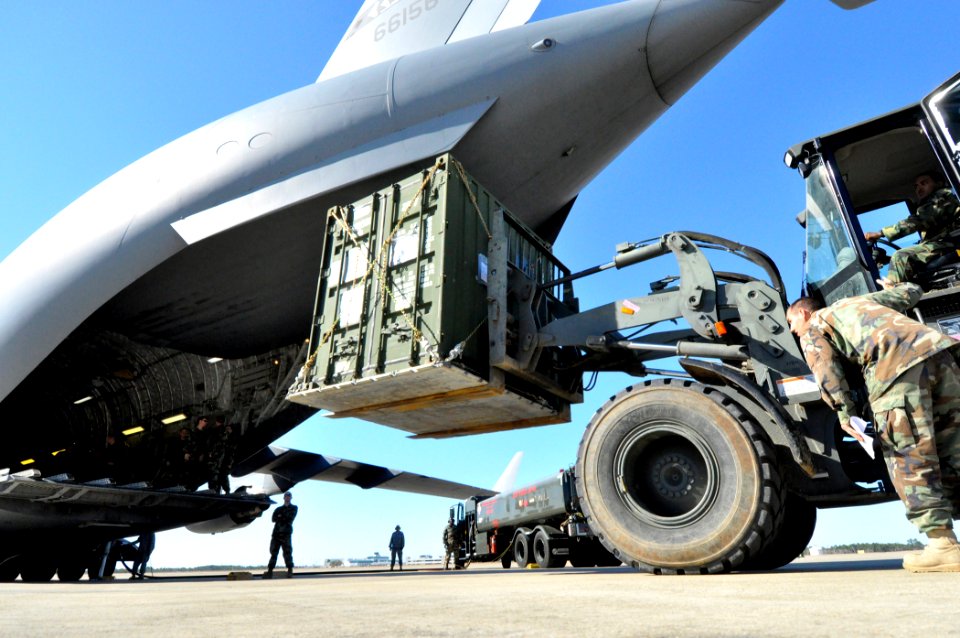 US Navy 100126-N-7367K-004 Seabees assigned to Naval Mobile Construction Battalion (NMCB) 7, load cargo onto a U.S. Air Force C-17 Globemaster