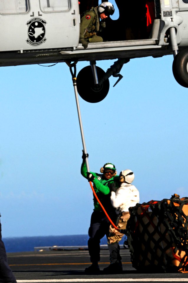 US Navy 100127-N-8878B-164 Sailors execute a vertical replenishment with a MH-60S Sea hawk helicopter
