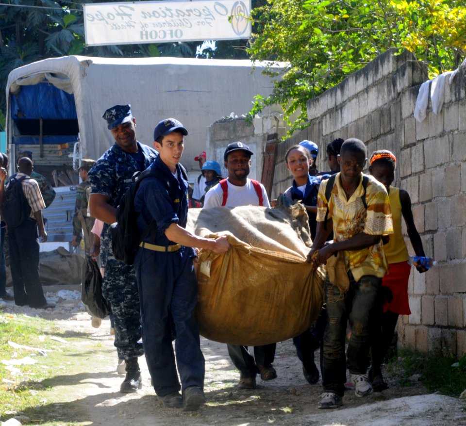 US Navy 100128-N-1831S-057 Crewmembers local Haitians takes supplies from the back of a U.N. truck to drop off at the Operation Hope for Children of Haiti clinic in Killick