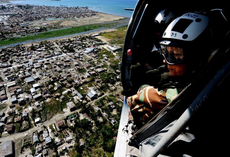 US Navy 100128-N-5345W-077 Rear Adm. Patricia Wolfe looks out from an MH-60S Sea Hawk helicopter while flying over the Haiti coastline en route to Port-au-Prince