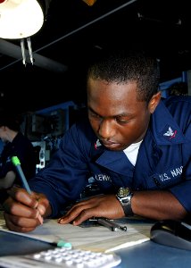 US Navy 100127-N-1082Z-019 Quartermaster 3rd Class Davonne Lewis, from Lincolnton, N.C., plots a course from the bridge of the amphibious dock landing ship USS Ashland (LSD 48)
