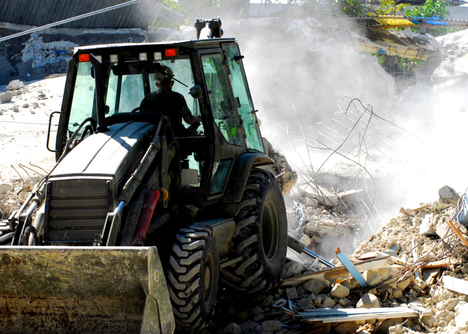 US Navy 100128-N-5244H-066 A Seabee removes rubble from a collapsed church in Baie De Grand Grove, Haiti