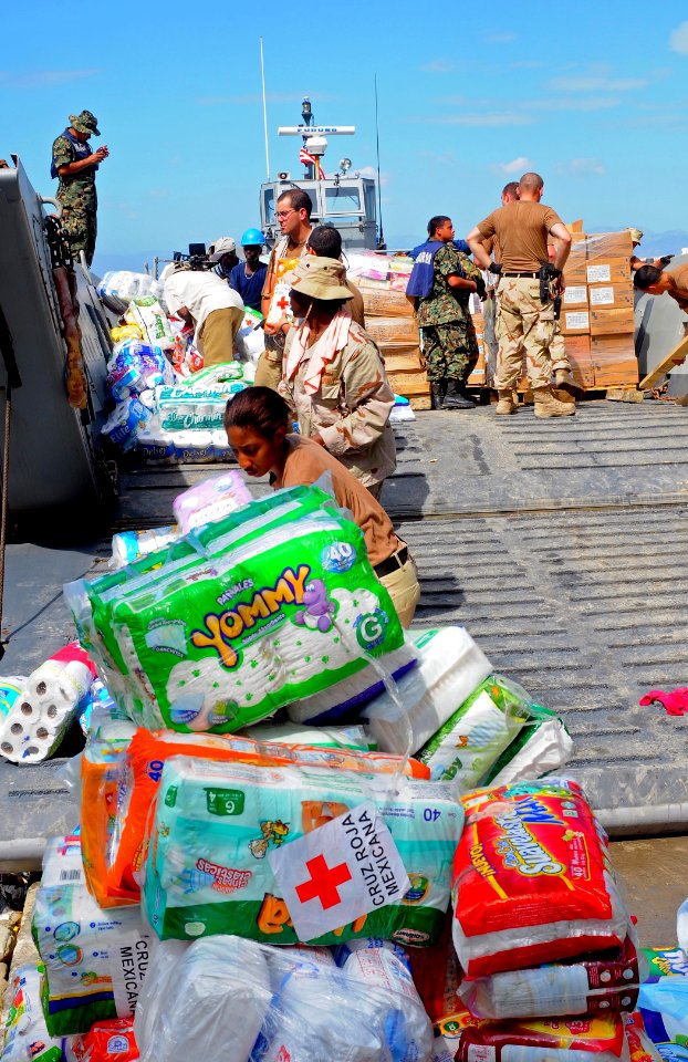 US Navy 100127-N-1831S-082 U.S. Navy Sailors assigned to Beach Master Unit (BMU) 2, and Mexican navy sailors transport baby supplies to the Killick Haitian Coast Guard Base