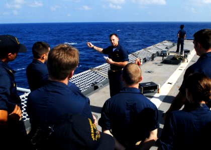 US Navy 100128-N-6692A-022 Lt. j.g. Jonathan Greenwald, training officer aboard the amphibious dock landing ship USS Harpers Ferry (LSD 49), demonstrates the proper procedure for firing a pencil flare