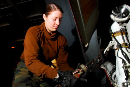 US Navy 100129-N-3327M-115 A sailor secures an aircraft aboard USS Nimitz