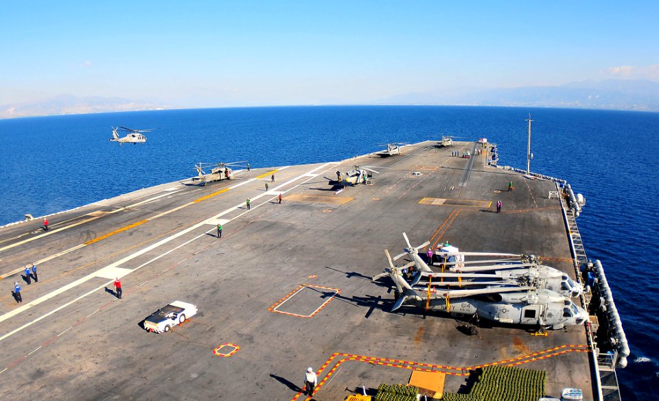 US Navy 100128-N-4774B-001 The Nimitz-class aircraft carrier USS Carl Vinson (CVN 70) conducts helicopter flight operations off the coast of Haiti