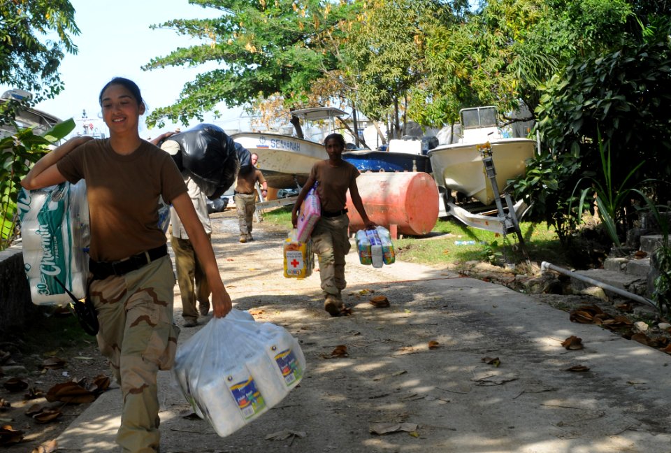 US Navy 100127-N-1831S-110 Gunner's Mate 3rd Class Kristen Luna, assigned to Beach Master Unit (BMU) 2, carries baby supplies to the Killick Haitian Coast Guard Base during a humanitarian supply delivery