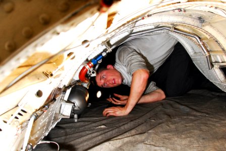 US Navy 100129-N-3327M-110 A Sailor evaluates an engine bay door aboard USS Nimitz