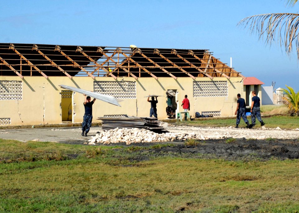 US Navy 100127-N-4971L-061 Sailors help local missionaries clear out a building mostly destroyed after the earthquake