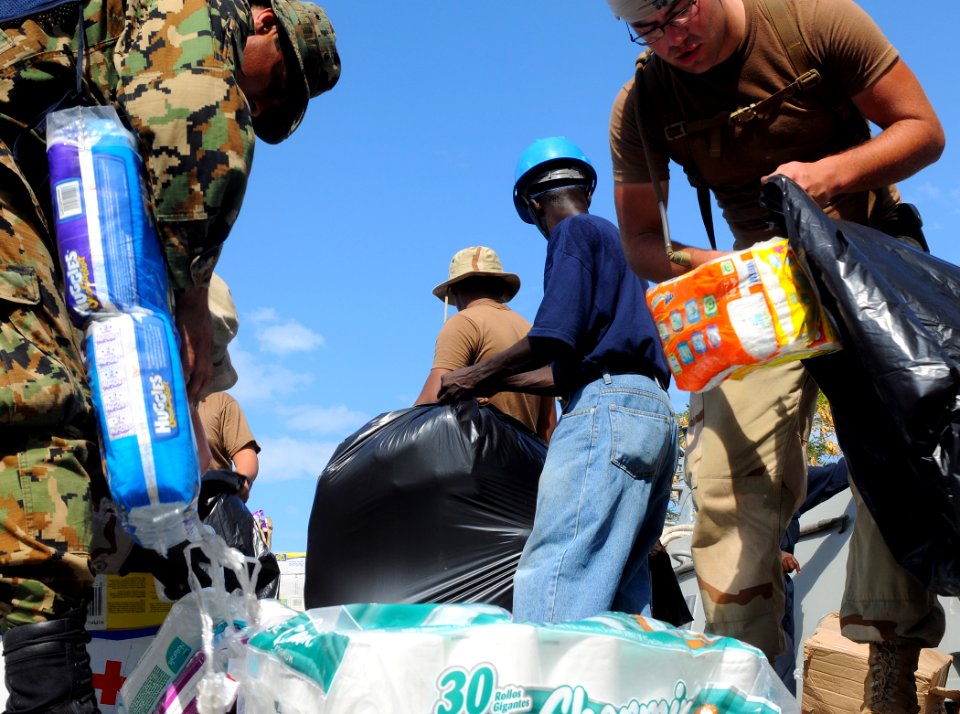 US Navy 100127-N-1831S-092 U.S. Navy Sailors assigned to Beach Master Unit (BMU) 2, and Mexican navy sailors transport baby supplies to the Killick Haitian Coast Guard Base