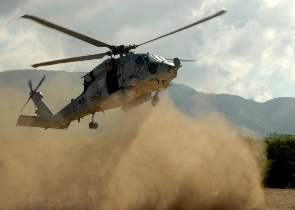 US Navy 100127-N-7638K-127 An HH-60H Sea Hawk helicopter assigned to Helicopter Anti-Submarine Squadron (HS) 7, brings Sailors ashore from the amphibious dock landing ship USS Fort McHenry (LSD 43)
