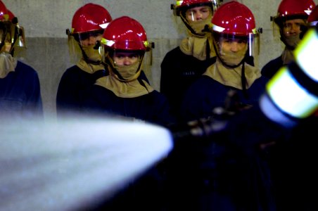 US Navy 100128-N-1251W-001 Sailors assigned to the aircraft carrier USS George Washington (CVN 73) watch a proper fire hose handling demonstration during a shipboard fire fighting class at the Center for Naval Engineering (CNE)