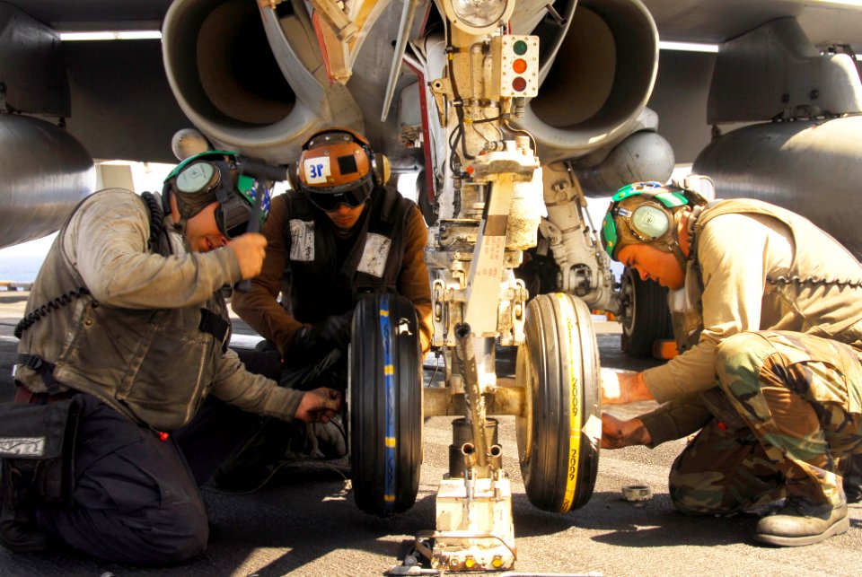 US Navy 100128-N-3327M-254 Sailors change tires on an aircraft aboard USS Nimitz