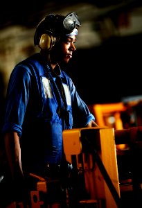US Navy 100127-N-5345W-035 viation Boatswain's Mate Airman Elliott Taylor waits on a forklift for a load of stores to drop to the hangar bay of the multi-purpose amphibious assault ship USS Bataan (LHD 5)