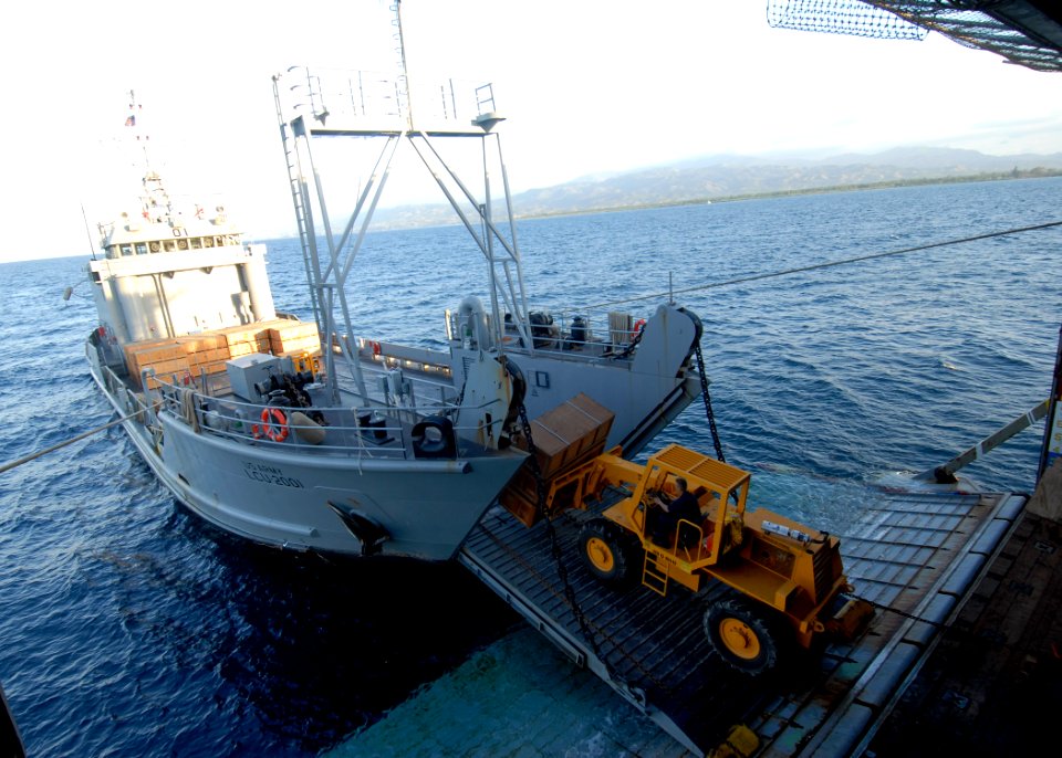 US Navy 100128-N-2000D-305 Sailors aboard the amphibious dock landing ship USS Carter Hall (LSD 50) transfer pallets of food rations from Carter Hall to U.S. Army Landing Craft Unit 2001