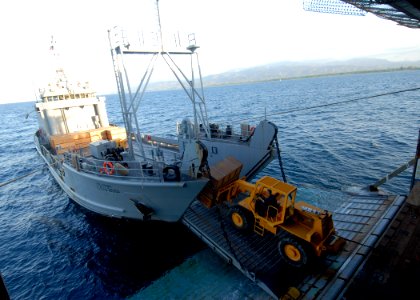 US Navy 100128-N-2000D-305 Sailors aboard the amphibious dock landing ship USS Carter Hall (LSD 50) transfer pallets of food rations from Carter Hall to U.S. Army Landing Craft Unit 2001