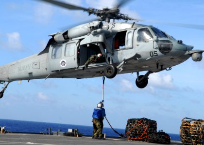 US Navy 100129-N-6692A-051 Sailors execute a vertical replenishment with an MH-60S Sea hawk helicopter aboard the amphibious dock landing ship USS Harpers Ferry (LSD 49)