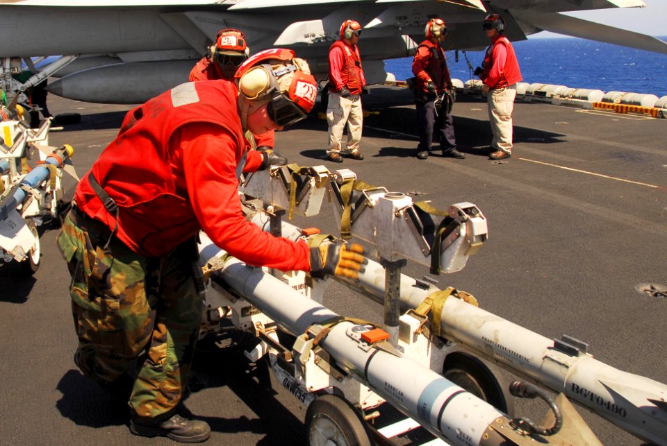 US Navy 100128-N-3327M-107 Sailors move ordnance on the flight deck of USS Nimitz